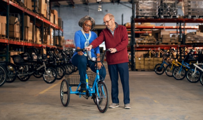 A customer tests out a bike with the help from business owner