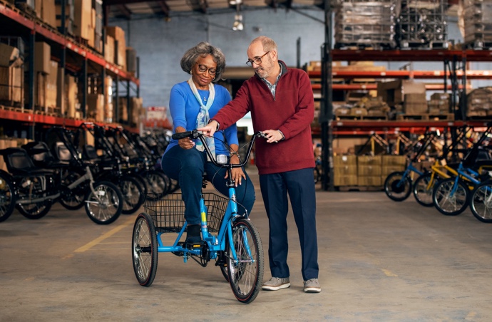 A customer tests out a bike with the help from business owner