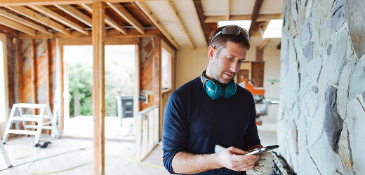 Contractor using mobile device on a job site