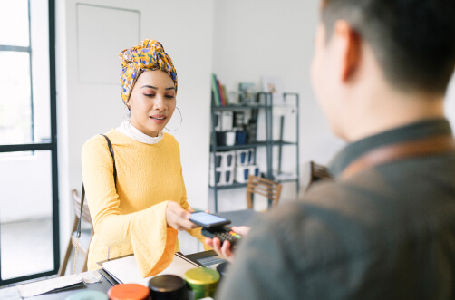 A woman pays using contactless technology at a store