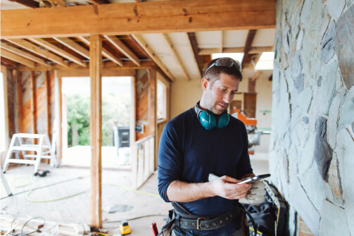 Contractor using mobile device on a job site