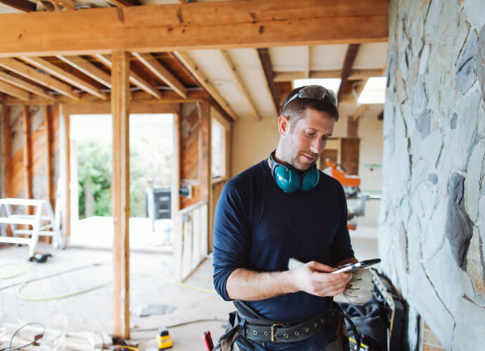 Contractor using mobile device on a job site