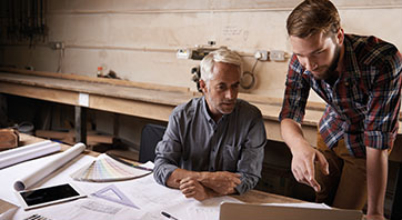 A business owner consults with an architect in the offices of a buillding project site
