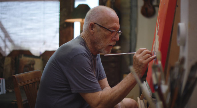 Video thumbnail of Southwest artist Chuck Caplinger painting oils on a canvas in his studio