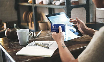 Small business owner purchases supplies on his tablet using his Chase Ink credit card