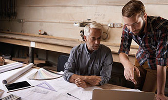 A business owner consults with an architect in the offices of a buillding project site