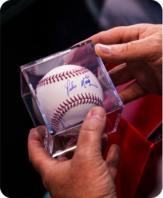 cardmember holds autographed baseball
