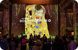 Marriott Bonvoy Cardmembers gather underneath projections in the Hall des Lumières 