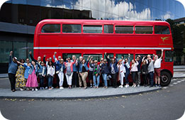 Marriott Bonvoy cardmembers pose in front of one of London's signature double decker buses