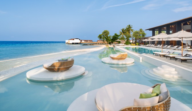 Luxurious oceanside pools and chaise longues at The Westin Maldives Miriandhoo Resort