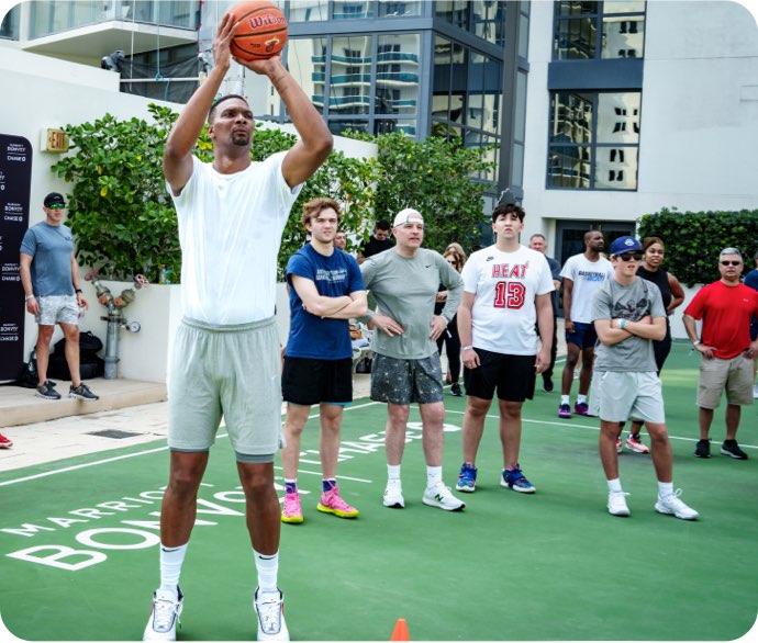Miami Heat player Chris Bosh plays basketball with Marriott Bonvoy cardmembers at the Miami Ultimate Basketball Experience