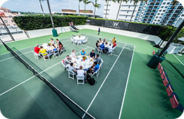 Marriott Bonvoy Cardmembers seated on the outdoor basketball court on the seventh floor of the W South Beach