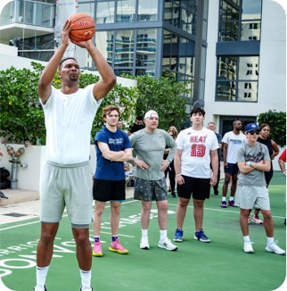 Miami Heat player Chris Bosh plays basketball with Marriott Bonvoy cardmembers at the Miami Ultimate Basketball Experience