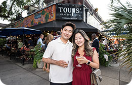 A couple poses outside of Toups Meatery, where the bayou themed party was held