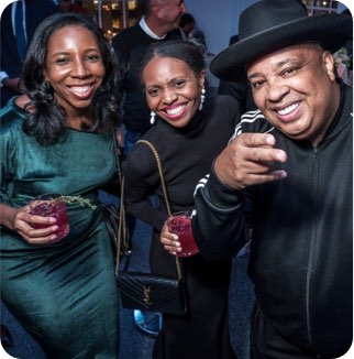 Cardmembers pose with special guest DJ Rev Run