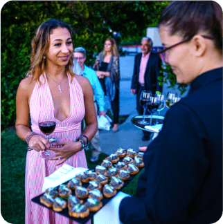 A patron enjoys wine and hors d'ouevres at the event in Sonoma Valley, California
