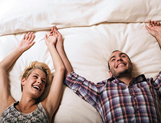 Couple laughing on bed