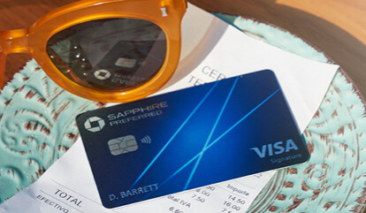 Sunglasses and Sapphire Preferred card sitting on top of a restaurant bill