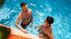 Two friends in the pool talking 