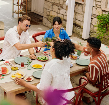 Two couple cheers at dinner table