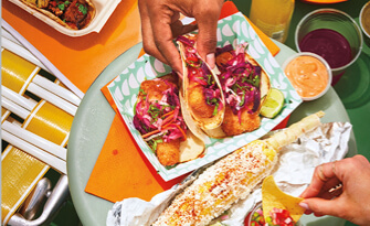 Tabletop view of a summer rolls and other Vietnamese side dishes