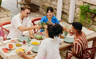 Two couple cheers at dinner table