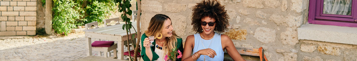 Two women laughing at a table