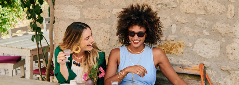 Two women laughing at a table
