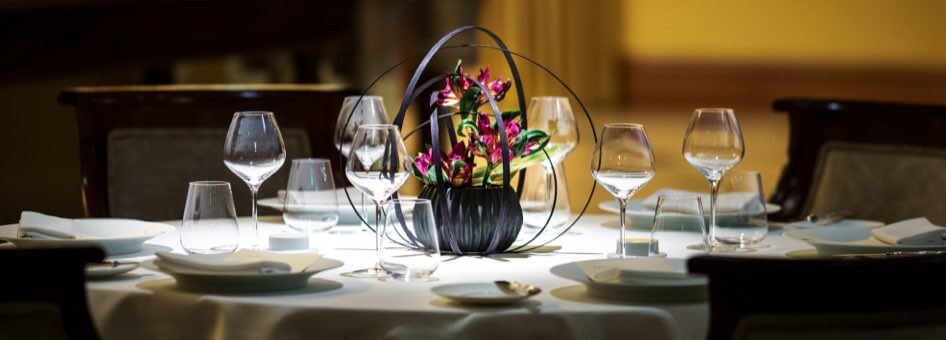 A floral centerpiece on a formal dining table