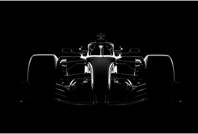 Studio shot of a racecar, silhouette on black that illuminates only the details