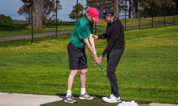 Renowned golf instructor David Leadbetter helps a cardmember with his swing