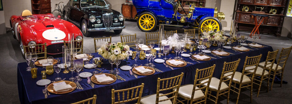 The tablescape at Evan's Garage surrounded by vintage cars