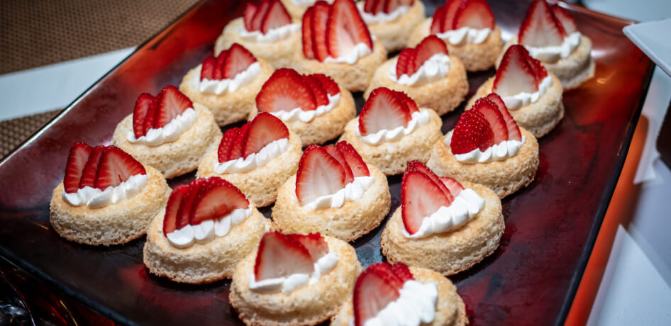 A plate of strawberry puff pastries, arranged in rows