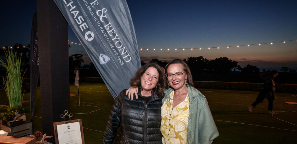 Cardmembers pose at sunset during the Friday night welcome reception