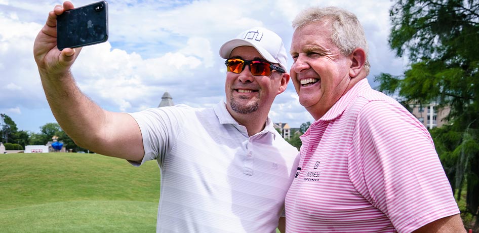 Attendee getting a selfie with Colin Montgomerie