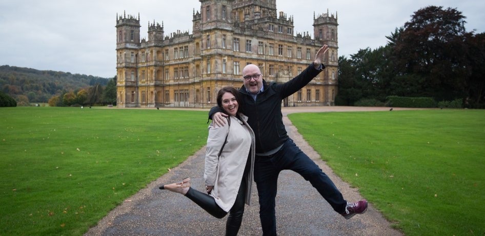 Two guests in front of Highclere Castle