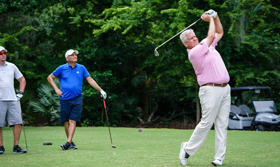 Colin Montgomerie swinging golf club at event