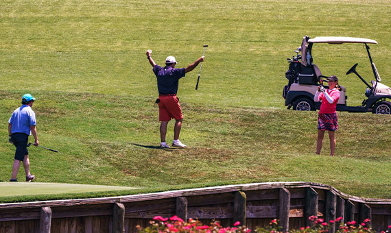 Golfer rejoicing on golf course