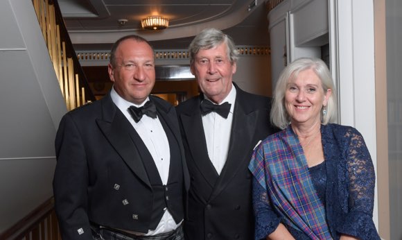 Cardmembers pose for a photo on the Royal Yacht Britannia