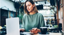 Woman seated at a desk working on a  laptop