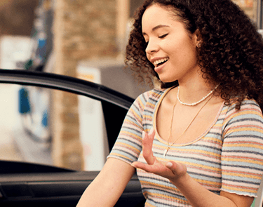 Woman smiling near car