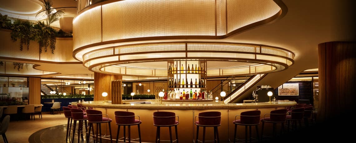 Sapphire Lounge at LaGuardia Airport, New York, with a circular bar counter, high stools, and warm lighting.