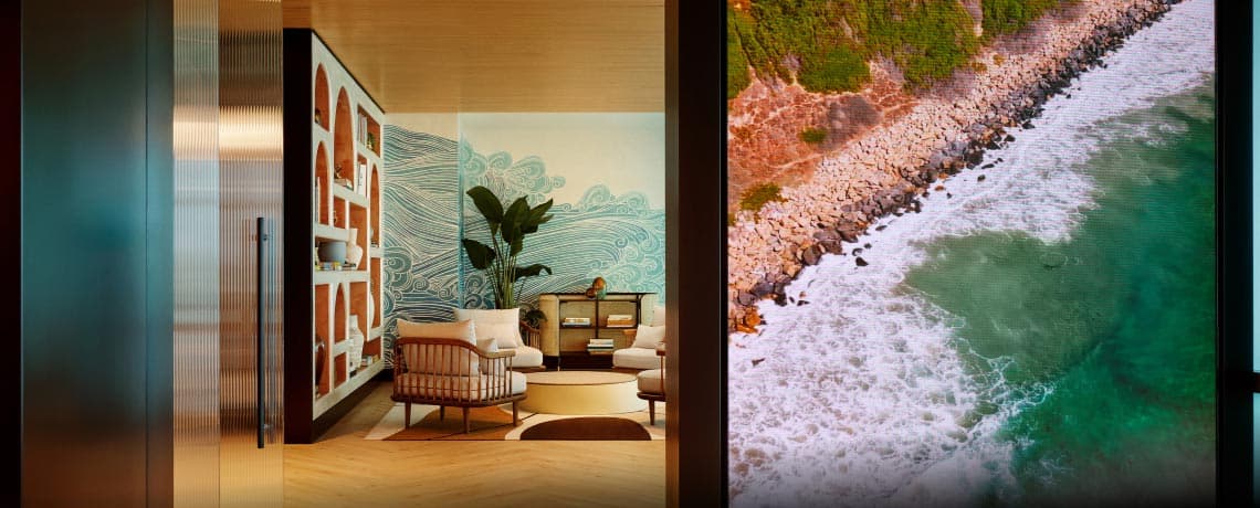 Sapphire Lounge at San Diego International Airport with contemporary furniture and a large mural of ocean waves.