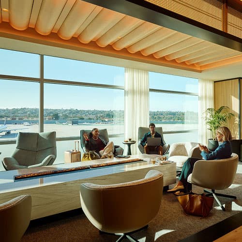 Two women and one man sitting in a lounge