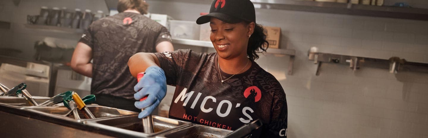 Worker making food with a smile