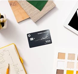 Overhead shot of Ink Buisness Unlimited card surrounded by fabric swatches, notebook, and tablet