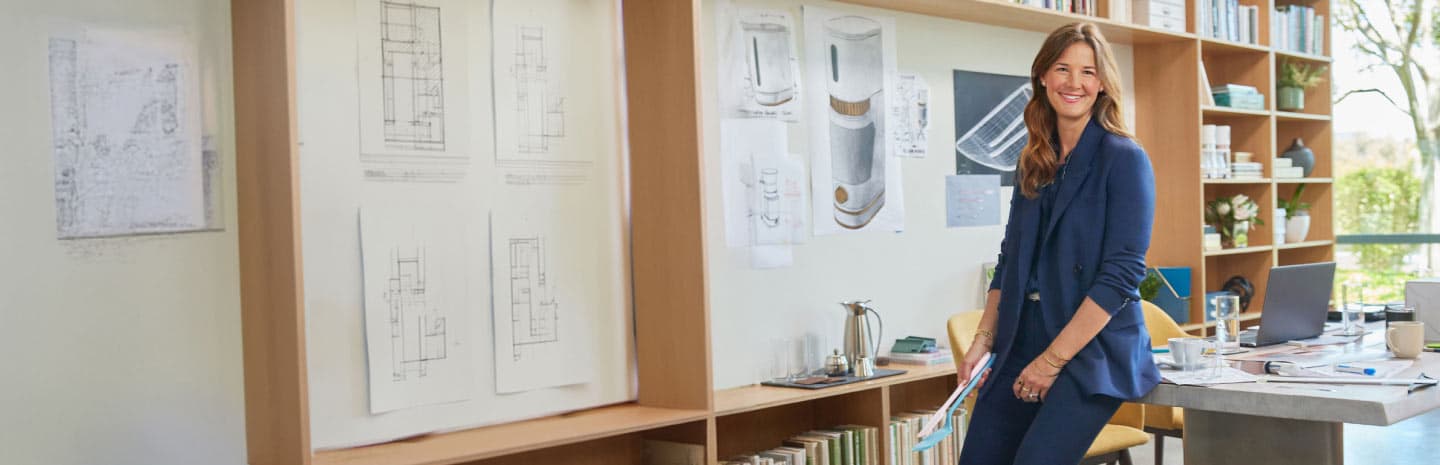 Lady in blue smiling at the camera