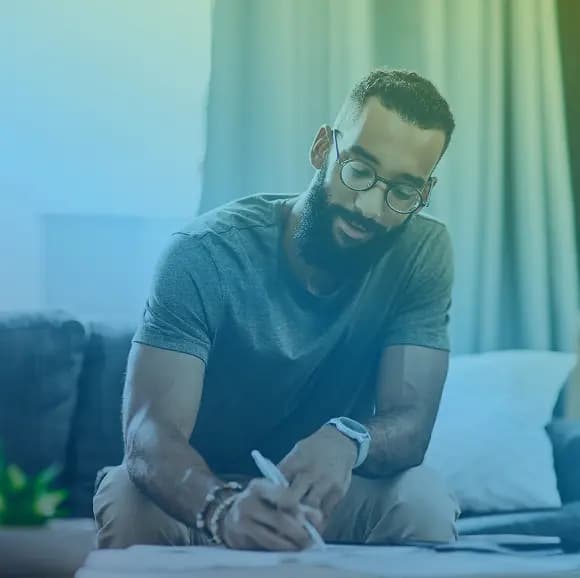 Person writing at desk