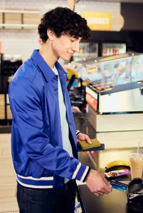 Boy paying for food and coffee