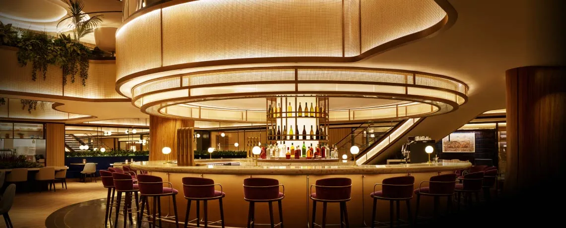 Sapphire Lounge at LaGuardia Airport, New York, with a circular bar counter, high stools, and warm lighting.